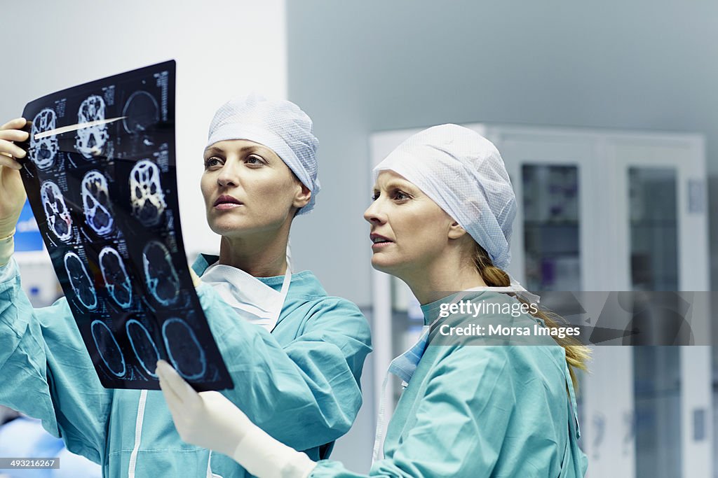 Surgeons examining x-ray in hospital