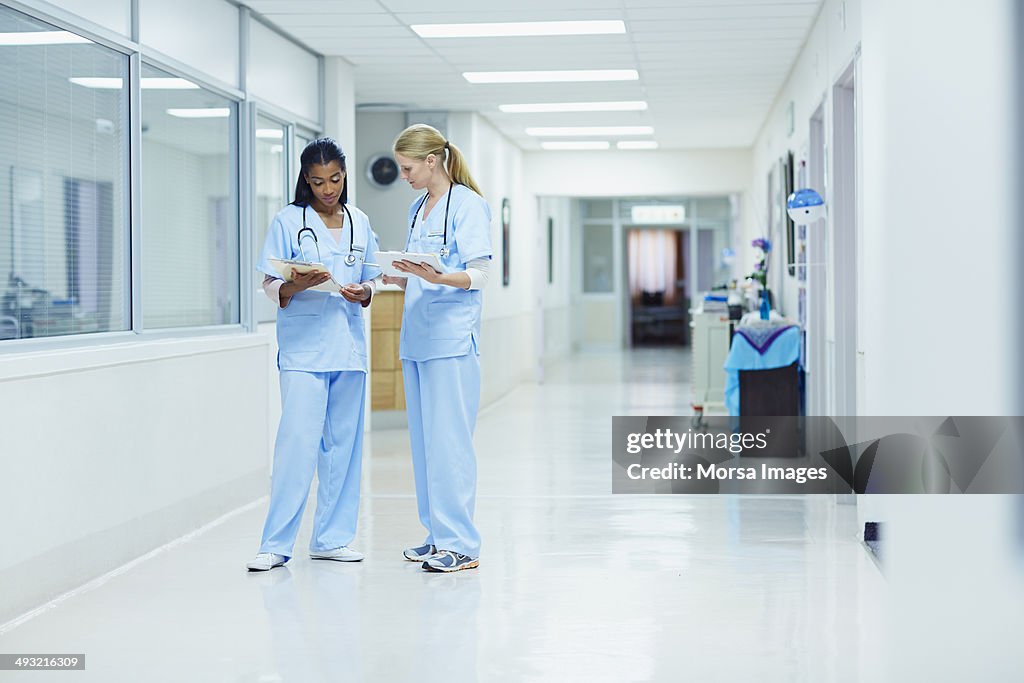 Nurses discussing medical documents in hospital