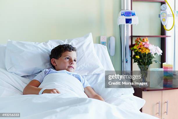 thoughtful boy relaxing in hospital - child hospital stock-fotos und bilder