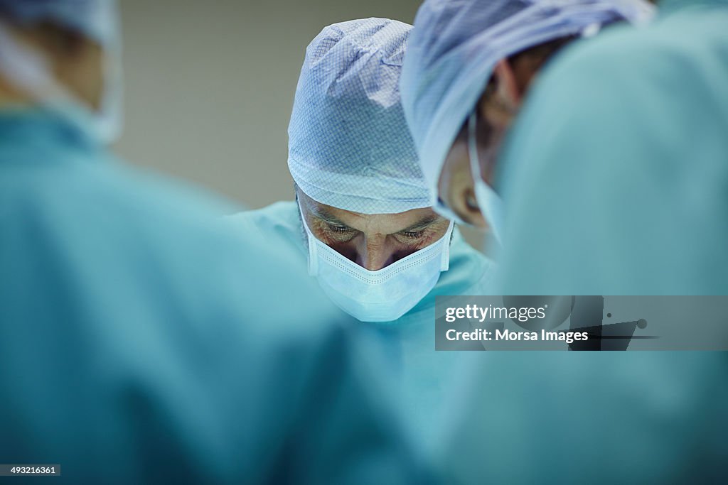 Surgeons working in operating room