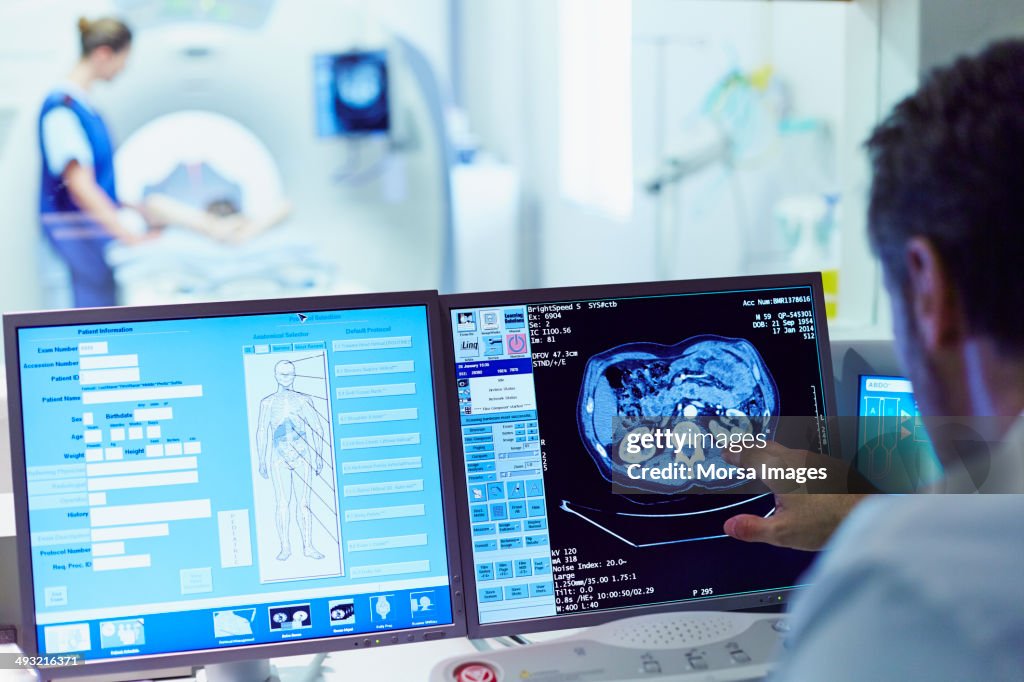 Doctor running CT scan from control room