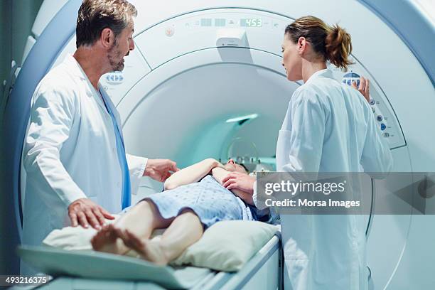 doctors preparing female patient for mri scan - test preparation stock pictures, royalty-free photos & images