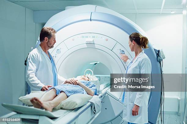 doctors preparing patient for mri scan - doctors equipment stockfoto's en -beelden