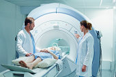 Doctors preparing patient for MRI scan