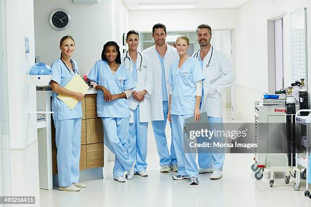 confident healthcare workers standing in hospital - medical occupation ストックフォトと画像