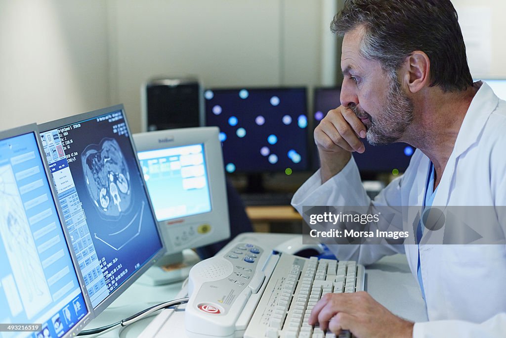 Doctor examining CT scan in control room