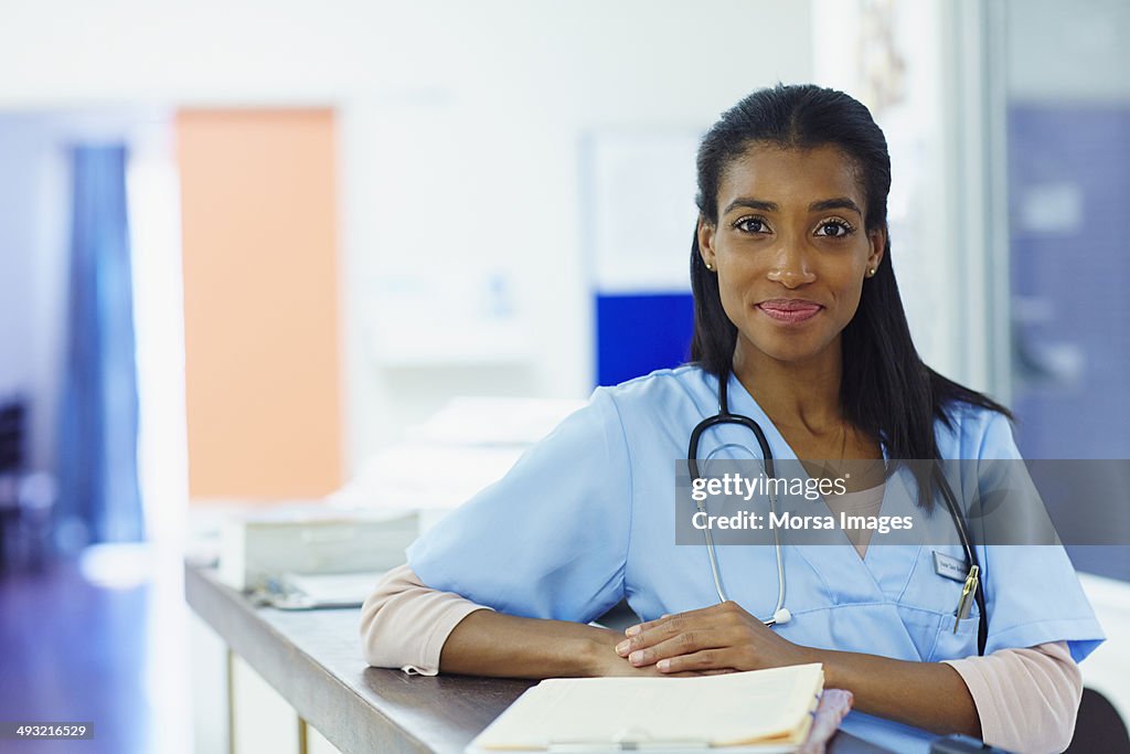 Confident nurse at hospital reception