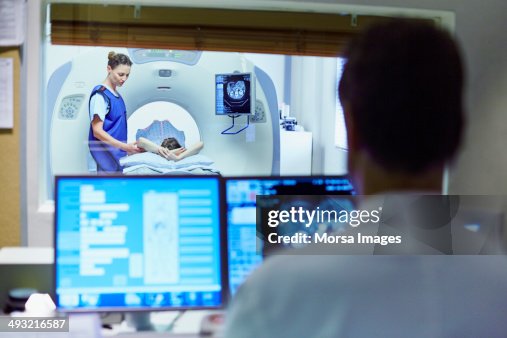 Doctor preparing patient for CT scan Doctor preparing patient for CT scan