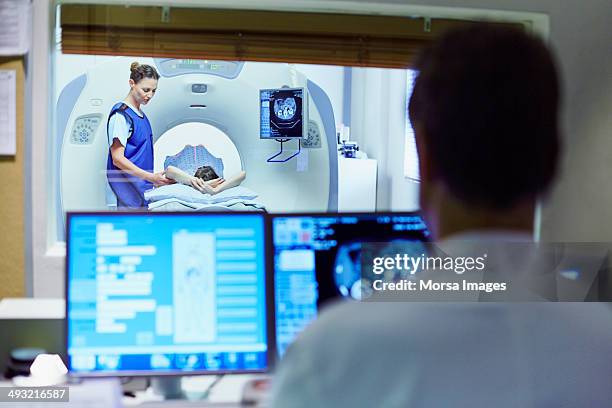 doctor preparing patient for ct scan - medical scanner stock pictures, royalty-free photos & images