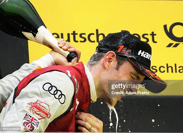 Jamie Green of Audi Sport Team Rosberg is saked in champagne by Mattias Ekstrom of Audi SPort Team Abt Sportsline after race 2 of the DTM German...