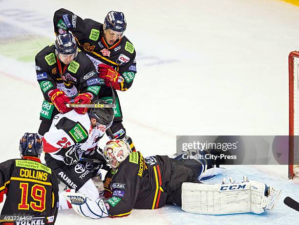 Patrick Hager of the Koelner Haien, Maxi Kammerer, Corey Mapses and Mathias Niederberger of the Duesseldorfer EG during the game between the...