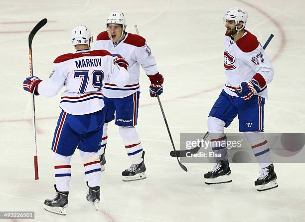 Andrei Markov of the Montreal Canadiens celebrates his second period goal with teammates Max Pacioretty and Brendan Gallagher against the New York...