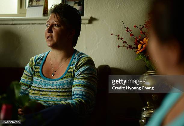 Veronica Ruiz share the memory of her brother Cristobal James Flores with family members. Lakewood, Colorado. May 22. 2014. Identification of remains...