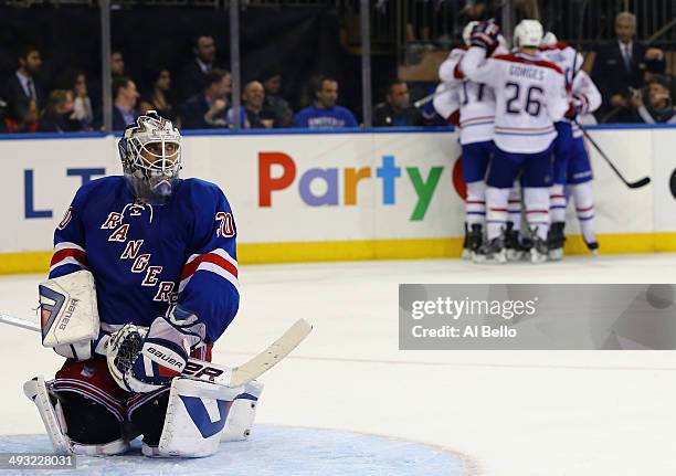 Henrik Lundqvist of the New York Rangers looks on as Daniel Briere of the Montreal Canadiens celebrates his third period goal in Game Three of the...