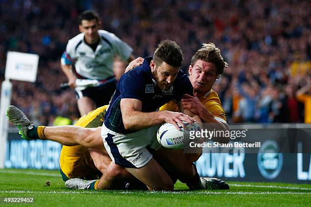 Tommy Seymour of Scotland scores his team's second try tackled by Michael Hooper of Australia during the 2015 Rugby World Cup Quarter Final match...