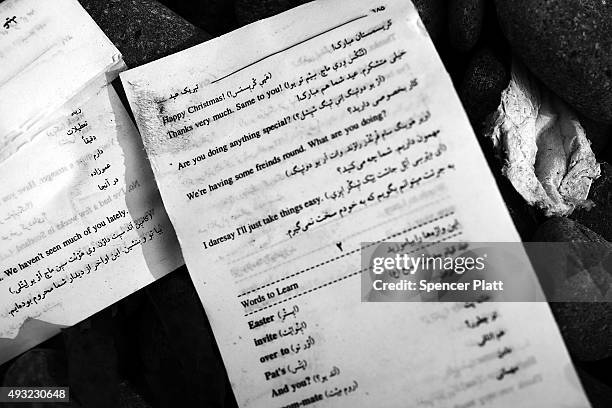 An Arabic to English translation sheet lays next to other items discarded by migrants arriving by boat from Turkey along a Lesbos beach where...