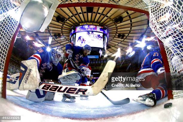 Henrik Lundqvist of the New York Rangers watches Daniel Briere of the Montreal Canadiens goal into the back of the net in Game Three of the Eastern...