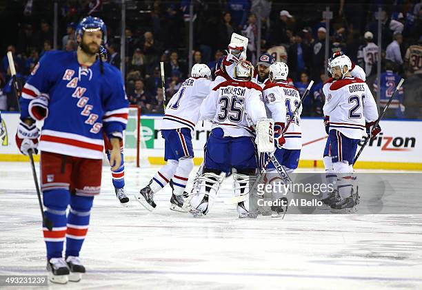 Alex Galchenyuk of the Montreal Canadiens is mobbed by his teammates after scoring the game winning overtime goal as Dominic Moore of the New York...