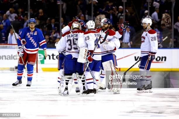 Alex Galchenyuk of the Montreal Canadiens is mobbed by his teammates after scoring the game winning overtime goal against the New York Rangers in...