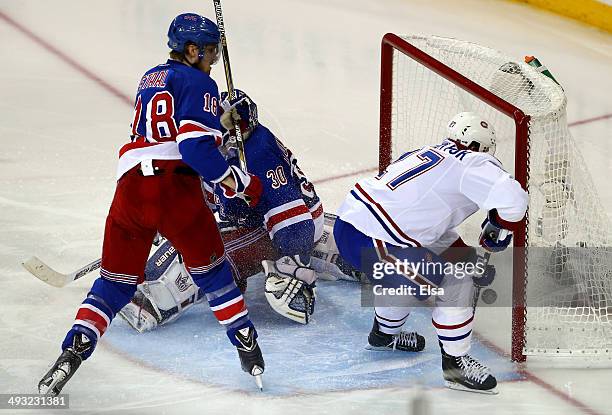 Alex Galchenyuk of the Montreal Canadiens shoots the puck past Henrik Lundqvist of the New York Rangers for the game winning overtime goal in Game...