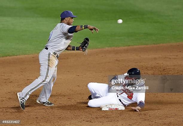 Shortstop Jean Segura of the Milwaukee Brewers attempts to turn a double play over pinch hitter Ryan Doumit of the Atlanta Braves in the seventh...