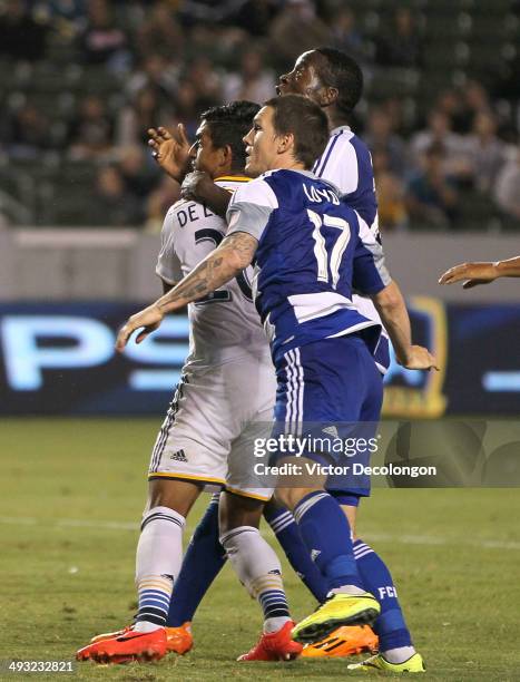 DeLaGarza of Los Angeles Galaxy and Zach Loyd and Je-Vaughn Watson of FC Dallas vie for position in the goal box in the second half during the MLS...