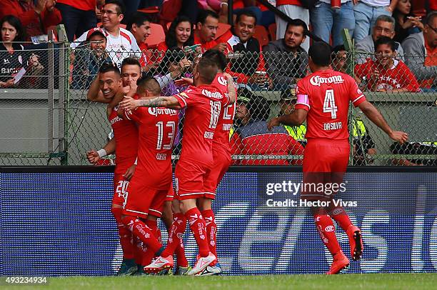 Fernando Uribe of Toluca celebrates with his teammates after scoring the first goal of his team during the 13th round match between Toluca and...