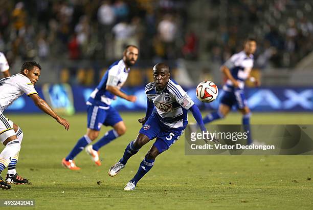 Jair Benitez of FC Dallas plays the ball off his shoulder as Kenney Walker of the Los Angeles Galaxy looks on during the second half of the MLS match...