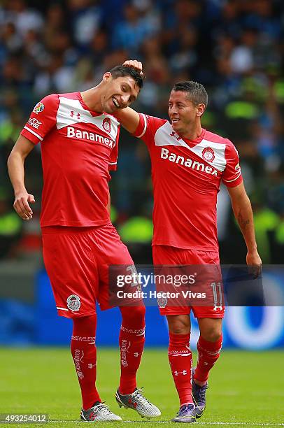 Carlos Esquivel of Toluca celebrates with his teammate Jordan Silva after scoring the second goal of his team during the 13th round match between...