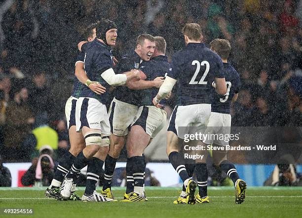 Mark Bennett of Scotland celebrates with teammates after scoring his team's third try during the 2015 Rugby World Cup Quarter Final match between...