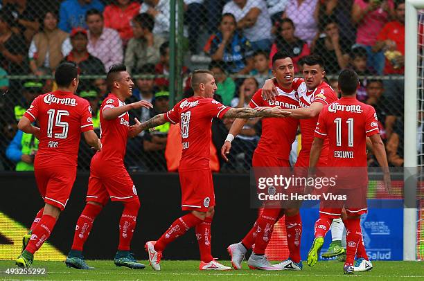 Fernando Uribe of Toluca celebrates with teammates after scoring the third goal of his team during the 13th round match between Toluca and Queretaro...