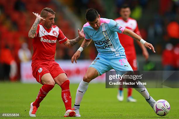 Dario Bottinelli of Toluca fights for the ball with Edgar Benitez of Queretaro during the 13th round match between Toluca and Queretaro as part of...