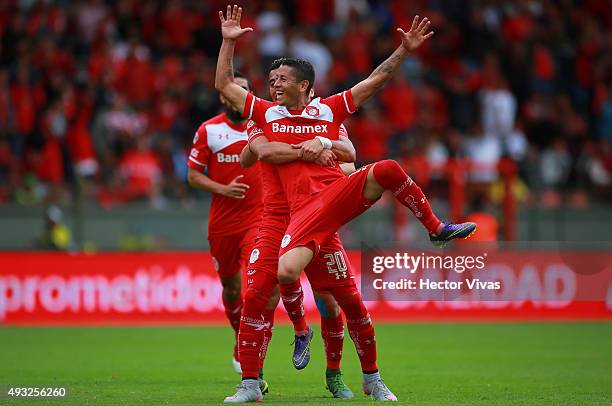 Carlos Esquivel of Toluca celebrates with teammates after scoring the fourth goal of his team during the 13th round match between Toluca and...