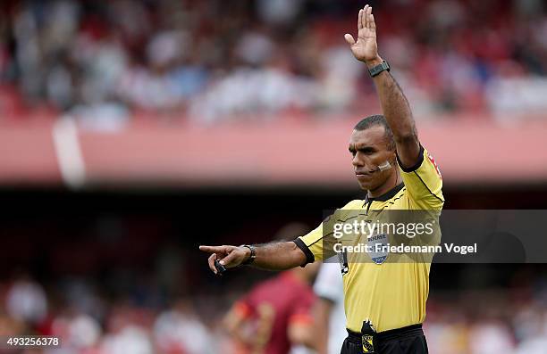 Referee Dewson Fernando Freitas da Silva signals a call during the match between Sao Paulo and Vasco for the Brazilian Series A 2015 at Estadio do...
