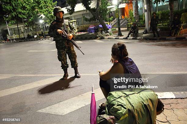 Thai soldier stands guard at Democracy monument after a curfew started at 10pm on May 22, 2014 in Bangkok. Thai soldiers began clearing the sites of...