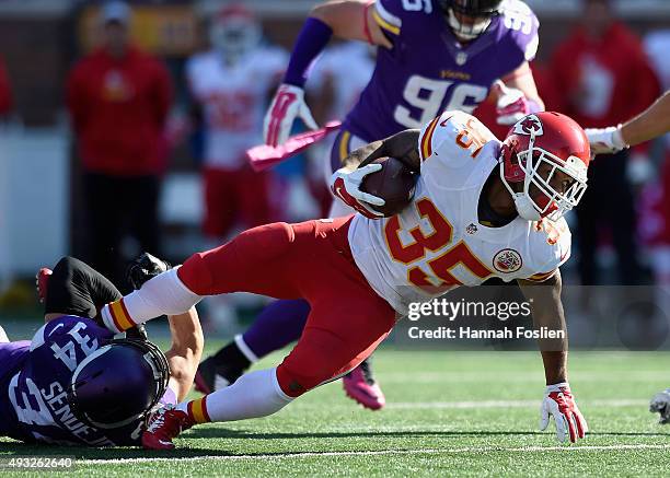 Andrew Sendejo of the Minnesota Vikings tackles Charcandrick West of the Kansas City Chiefs during the fourth quarter of the game on October 18, 2015...