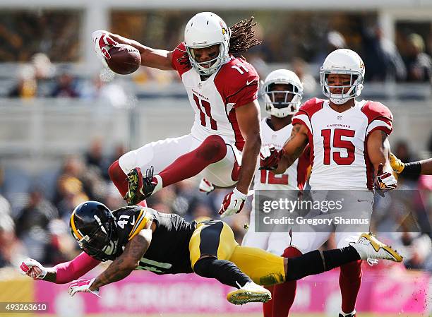 Larry Fitzgerald of the Arizona Cardinals leaps over Antwon Blake of the Pittsburgh Steelers in the 1st half of the gmae at Heinz Field on October...