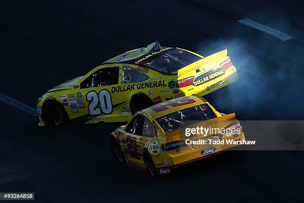 Joey Logano, driver of the Shell Pennzoil Ford, makes contact with Matt Kenseth, driver of the Dollar General Toyota, during the NASCAR Sprint Cup...