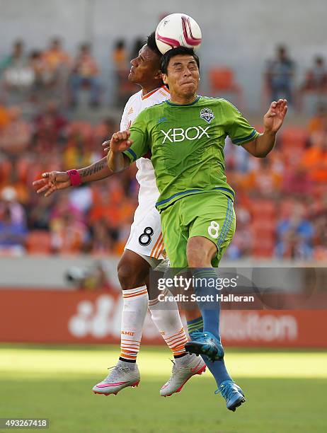 Gonzalo Pineda of the Seattle Sounders FC and Luis Garrido of the Houston Dynamo battle for the ball in the first half of their game at BBVA Compass...