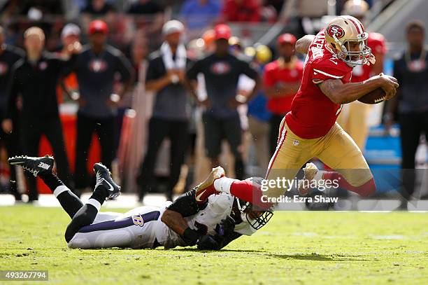Quarterback Colin Kaepernick of the San Francisco 49ers is tackled by cornerback Jimmy Smith of the Baltimore Ravens during their NFL game at Levi's...