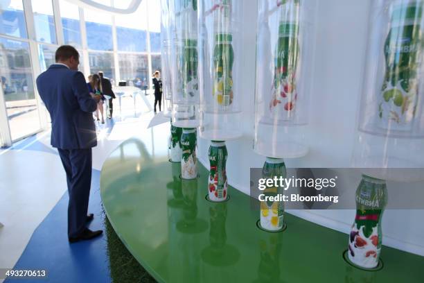 Bottles of yoghurt drinks stand on a display stand at the Danone SA corporate pavilion at the St. Petersburg International Economic Forum in Saint...