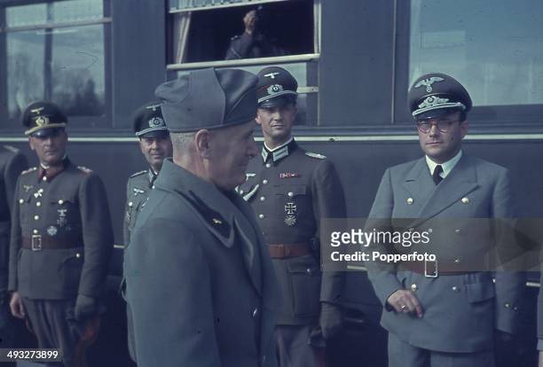 1st OCTOBER: Italian Prime Minister Benito Mussolini meets with Axis officers at the railway station in Florence, Italy during a visit by German...
