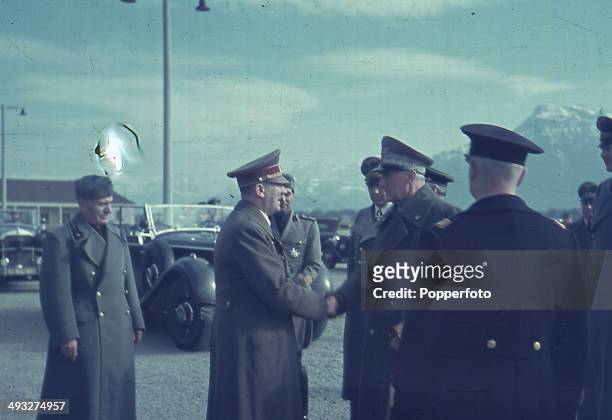 German Chancellor Adolf Hitler and Italian Prime Minister Benito Mussolini meet with Italian Commander Rodolfo Graziani circa 1940.