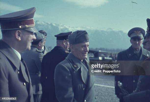 German Chancellor Adolf Hitler talks with Italian Prime Minister Benito Mussolini and Italian Marshal Rodolfo Graziani during Hitler's visit to the...