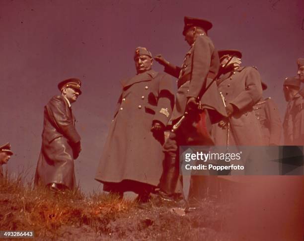 German Chancellor Adolf Hitler talks with Italian Prime Minister Benito Mussolini and German Field Marshal Gunther von Kluge , commander of the 4th...