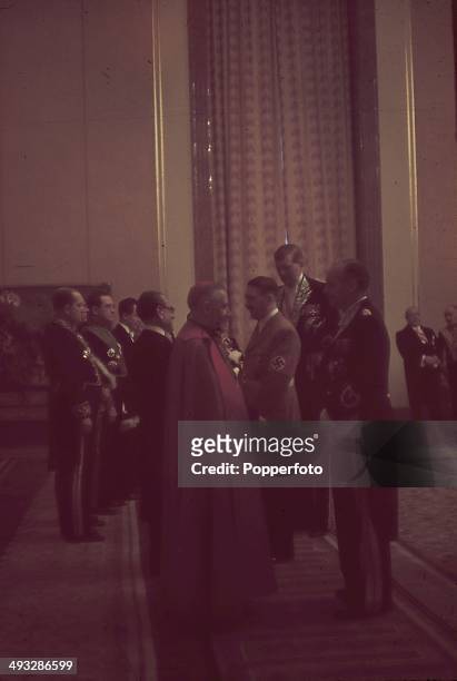 1st JANUARY: German Chancellor Adolf Hitler and Foreign Minister Joachim von Ribbentrop in diplomatic dress greet guests including papal nuncio...