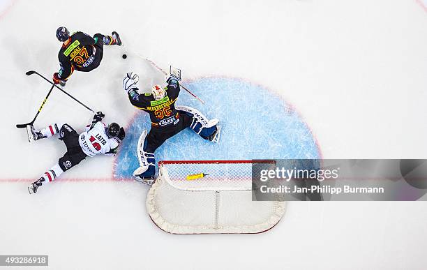 Tim Schuele and Mathias Niederberger of Duesseldorfer EG against Nick Latta of Koelner Haie during the DEL match between Duesseldorfer EG and Koelner...