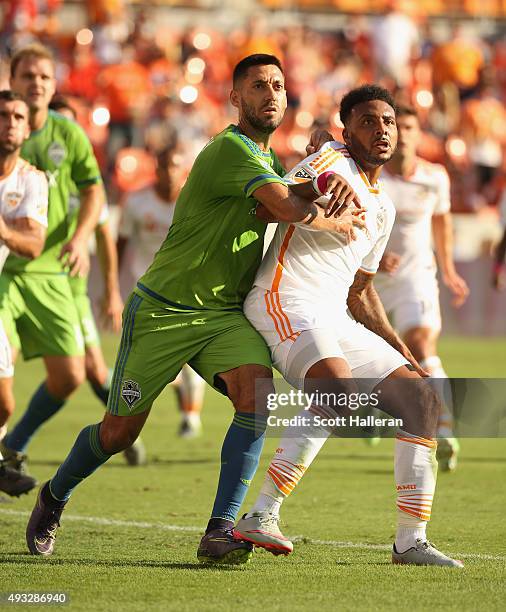 Clint Dempsey of the Seattle Sounders FC and Giles Barnes of the Houston Dynamo battle for position in front of the goal in the first half of their...