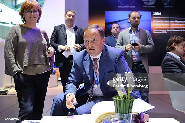 Igor Komarov, chief executive officer of the United Rocket and Space Co., center, pauses between sessions at the St. Petersburg International...