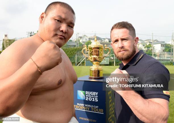 Sumo world championships openweight champion Naranbat Gankhuyag of Mongolia and rugby union player Shane Williams of Wales pose with the Webb Ellis...